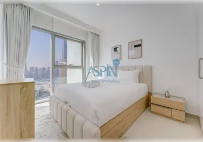 a bedroom with a large bed and a large window at Downtown Views II - Burjkhalifa fireworks in Dubai