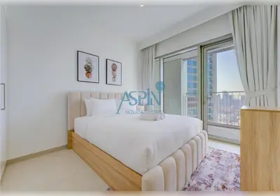 a bedroom with a large bed and a large window at Downtown Views II - Burjkhalifa fireworks in Dubai