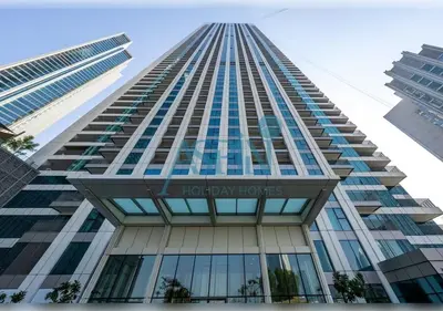 a tall building with the words holiday homes at Downtown Views II - Burjkhalifa fireworks in Dubai