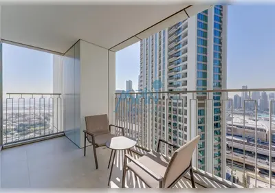 an apartment balcony with chairs and a view of a city at Downtown Views II - Burjkhalifa fireworks in Dubai