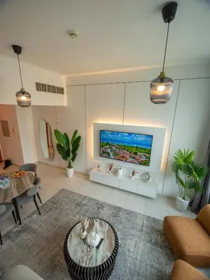 a living room with a tv on a wall at Wonderful 2bd with full marina view HIGH FLOOR in Dubai