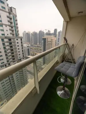 a balcony with a chair and a view of a city at Wonderful 2bd with full marina view HIGH FLOOR in Dubai