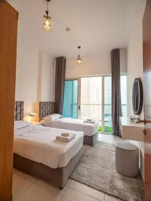 a hotel room with two beds and a window at Wonderful 2bd with full marina view HIGH FLOOR in Dubai