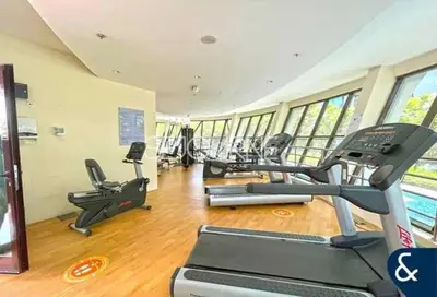 a gym with treadmills and ellipticals in a building at Cozy & Bright 1BR La Riviera Estate A in Dubai