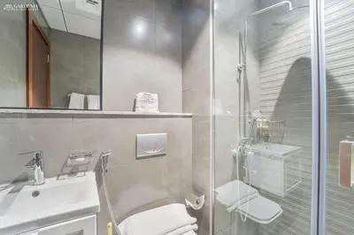a bathroom with a shower and a toilet and a sink at O2 Tower JVC, Cozy Home, Peaceful Studio Apartment in Dubai