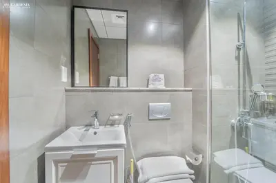 a bathroom with a toilet and a sink and a shower at O2 Tower JVC, Cozy Home, Peaceful Studio Apartment in Dubai
