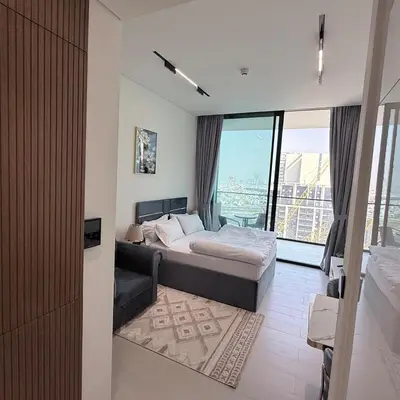 a bedroom with a bed and a large window at A place like home for relaxation in Dubai