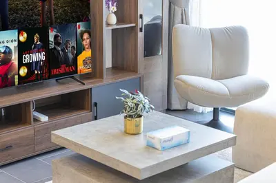a living room with a table and a couch at Luxurious Crest Tower Suites By Hostiva- Burj View in Dubai