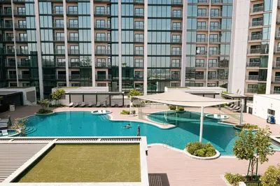 a large apartment building with a large swimming pool at Luxurious Crest Tower Suites By Hostiva- Burj View in Dubai
