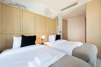 a bedroom with two beds with white towels on them at 2BR Vida Dubai Mall Tower 2 Direct Mall Access in Dubai