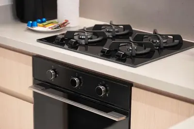 a black stove top on top of a kitchen counter at 2BR Vida Dubai Mall Tower 2 Direct Mall Access in Dubai
