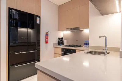 a kitchen with a stainless steel refrigerator and a sink at 2BR Vida Dubai Mall Tower 2 Direct Mall Access in Dubai