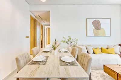 a dining room with a table and a couch at PVH - Downtown Magnificent 2BR - Vida Dubai Mall in Dubai