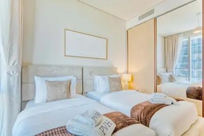a hotel room with two beds and a mirror at PVH - Downtown Magnificent 2BR - Vida Dubai Mall in Dubai