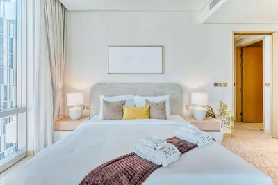 a bedroom with a large bed with towels on it at PVH - Downtown Magnificent 2BR - Vida Dubai Mall in Dubai