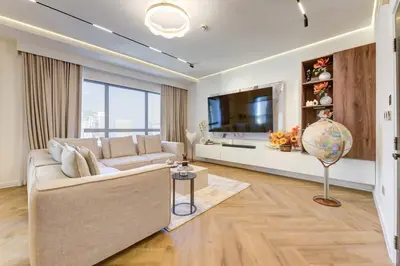 a living room with a couch and a tv at 2 Bedroom Apartment, JBR Beach with Dubai Eye View in Dubai