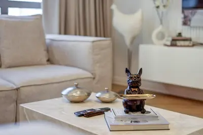 a dog figurine on a table in a living room at 2 Bedroom Apartment, JBR Beach with Dubai Eye View in Dubai