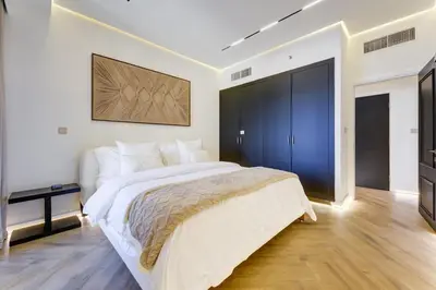 a bedroom with a large bed and a television at 2 Bedroom Apartment, JBR Beach with Dubai Eye View in Dubai