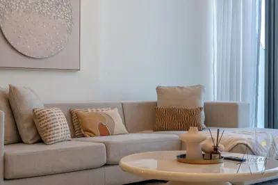 a living room with a couch and a coffee table at Elegant & Spacious 2-BR Hideaway Riviera Bliss in Dubai