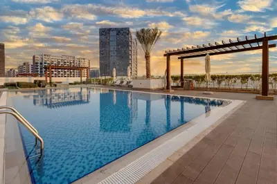 a large swimming pool on the roof of a building at Elegant & Spacious 2-BR Hideaway Riviera Bliss in Dubai