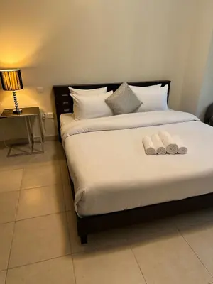 a bedroom with a bed with two towels on it at Fantastic 1 bed apt near Marina & Jumeira Beach in Dubai
