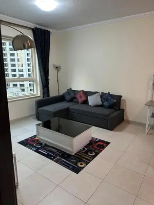 a living room with a couch and a coffee table at Fantastic 1 bed apt near Marina & Jumeira Beach in Dubai