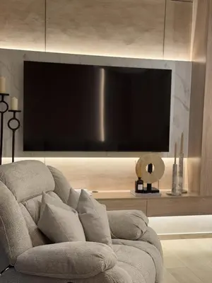 a living room with a couch and a flat screen tv at Palace Residences, Lux 1BR Apartment, Lagoon View in Dubai
