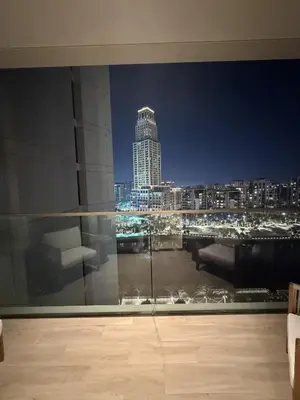 a room with a view of a city at night at Palace Residences, Lux 1BR Apartment, Lagoon View in Dubai
