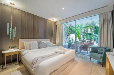 a bedroom with a large bed and a sliding glass door at FIVE Palm-Private Pool and Garden-Luxury Suite in Dubai