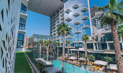 an apartment building with a swimming pool and palm trees at FIVE Palm-Private Pool and Garden-Luxury Suite in Dubai
