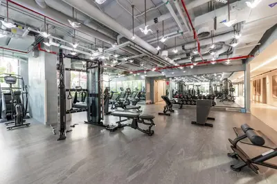a gym with several treadmills and exercise equipment at Minutes Walk To Dubai Mall Studio With All Comfort in Dubai