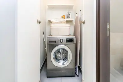 a washer and dryer in a small room at 1-Bedroom Apartment near Dubai Frame High Floor in Dubai
