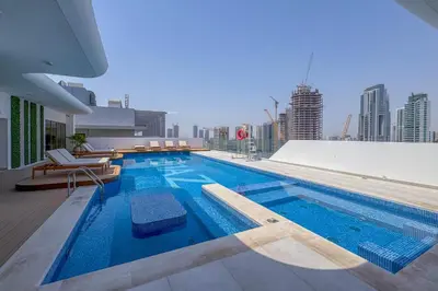 a swimming pool on the roof of a building at Pearl House I JVC- 5 Star Facilities- Magnificent Apartment in Dubai