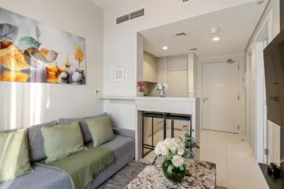 a living room with a couch and a fireplace at Burj Khalifa&City View 1BR, Near Dubai Water Canal, Vera Tower, Business Bay by Morada Holidays in Dubai