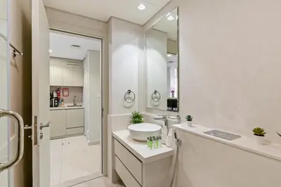 a bathroom with a sink and a large mirror at Burj Khalifa&City View 1BR, Near Dubai Water Canal, Vera Tower, Business Bay by Morada Holidays in Dubai