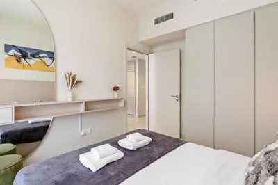 a bedroom with a bed and a mirror at Burj Khalifa&City View 1BR, Near Dubai Water Canal, Vera Tower, Business Bay by Morada Holidays in Dubai