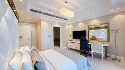 a bedroom with a bed and a desk and a television at TRIDENT GRAND JBR I BEACHFRONT 2-Bedroom Apartment I Beautiful Palm and Ocean Views I Amazing Balcony Space in Dubai