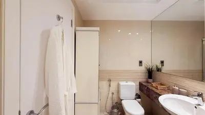 a bathroom with a toilet and a sink and a mirror at TRIDENT GRAND JBR I BEACHFRONT 2-Bedroom Apartment I Beautiful Palm and Ocean Views I Amazing Balcony Space in Dubai