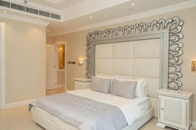 a bedroom with a white bed with a large headboard at TRIDENT GRAND JBR I BEACHFRONT 2-Bedroom Apartment I Beautiful Palm and Ocean Views I Amazing Balcony Space in Dubai