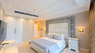 a bedroom with a large bed and a television at TRIDENT GRAND JBR I BEACHFRONT 2-Bedroom Apartment I Beautiful Palm and Ocean Views I Amazing Balcony Space in Dubai
