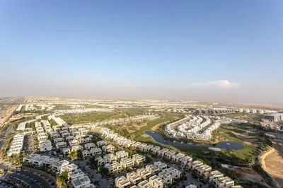 an aerial view of a city with condos at Sky-High Luxury Studio Overlooking Trump Golf Club-Carson A, DAMAC Hills, Dubai in Dubai