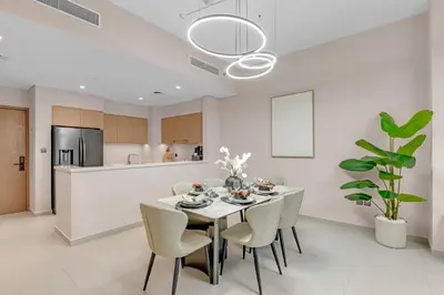 a kitchen and dining room with a table and chairs at Full Burj Khalifa 3BR in Act Towers in Dubai