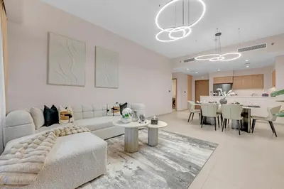 a living room with a couch and a table at Full Burj Khalifa 3BR in Act Towers in Dubai