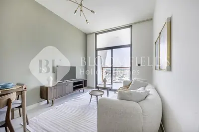 a living room with a couch and a tv at 202-Bloomfields Iconic 1br Binghatti Avenue in Dubai