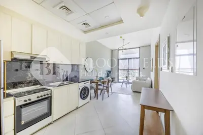 a kitchen and dining room with a table and chairs at 202-Bloomfields Iconic 1br Binghatti Avenue in Dubai
