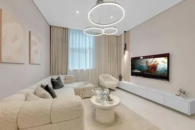 a living room with a couch and a tv at Lavish & Cozy 1BR Apt in the heart of Business Bay in Dubai