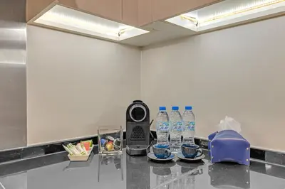 a counter with bottles of water on a table at Lavish & Cozy 1BR Apt in the heart of Business Bay in Dubai