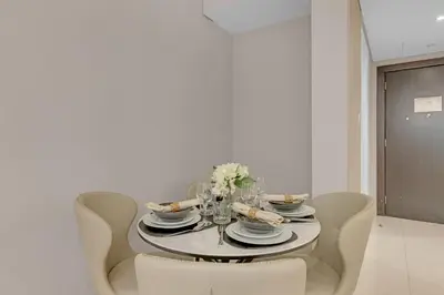 a dining room with a table with chairs and a tableablish at Lavish & Cozy 1BR Apt in the heart of Business Bay in Dubai