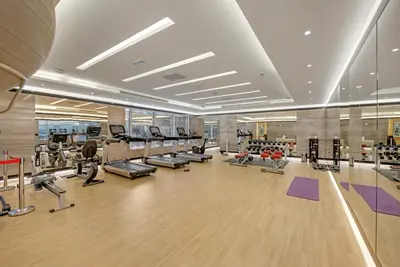 a gym with treadmills and cardio equipment in a building at Lavish & Cozy 1BR Apt in the heart of Business Bay in Dubai