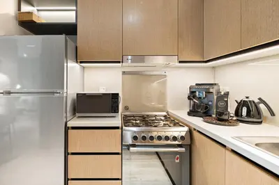 a kitchen with a stove and a refrigerator at Ultra Luxury! Burj Crown ! 1BR ! Beautiful View in Dubai